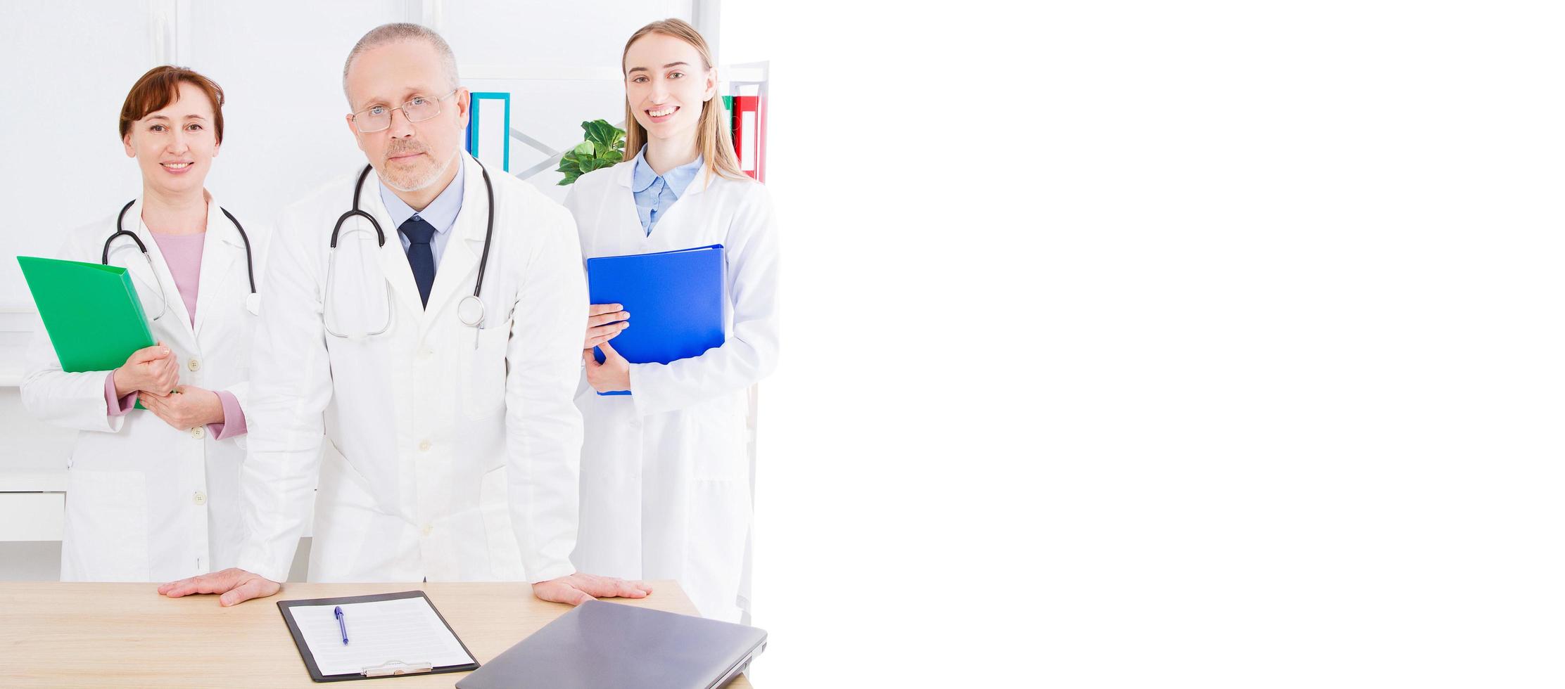 doctor posing with medical staff,nurse in office and copy space, banner of billboard photo