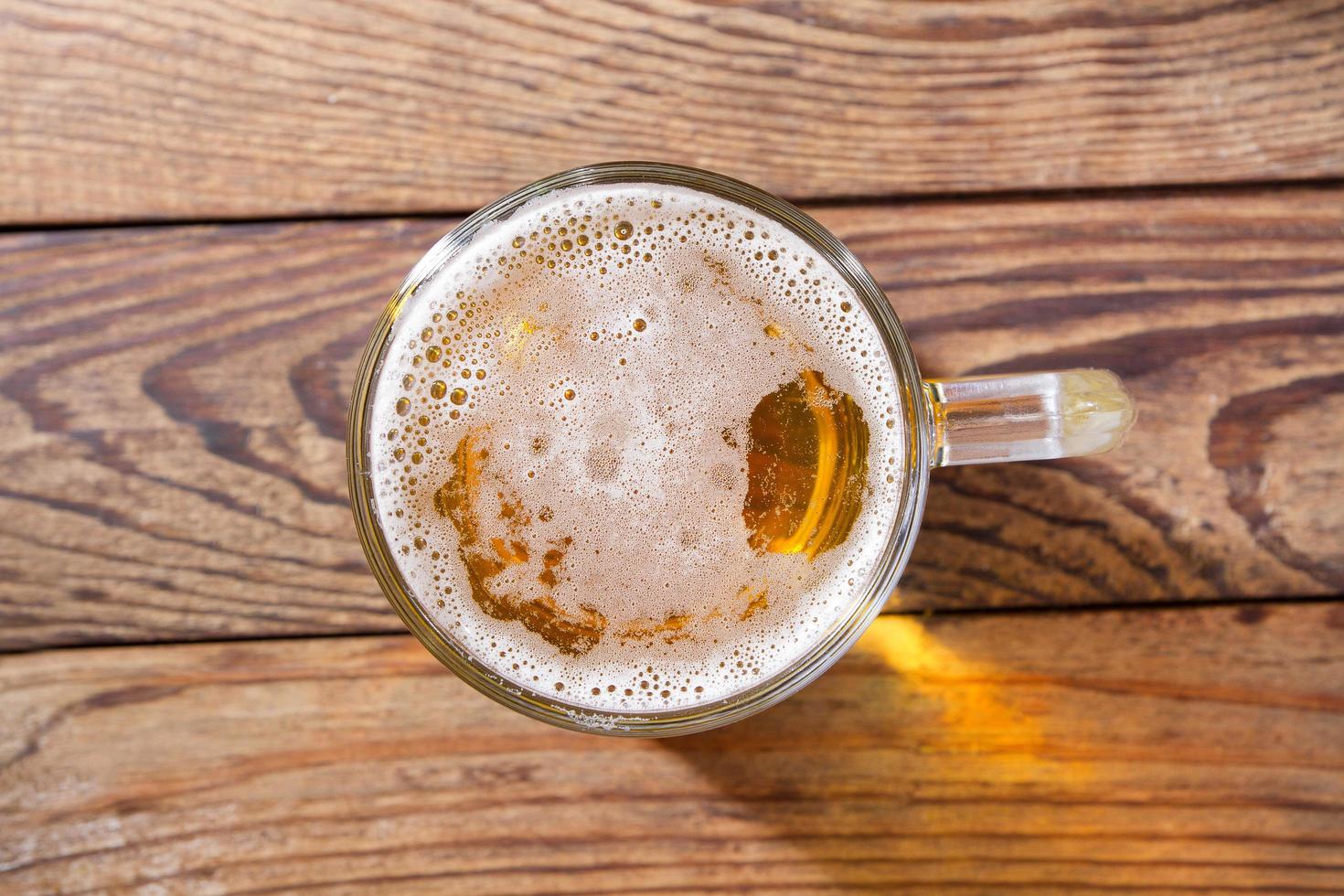 glass of beer on wooden background, top view. Mock up. Copy space.Template. Blank. photo