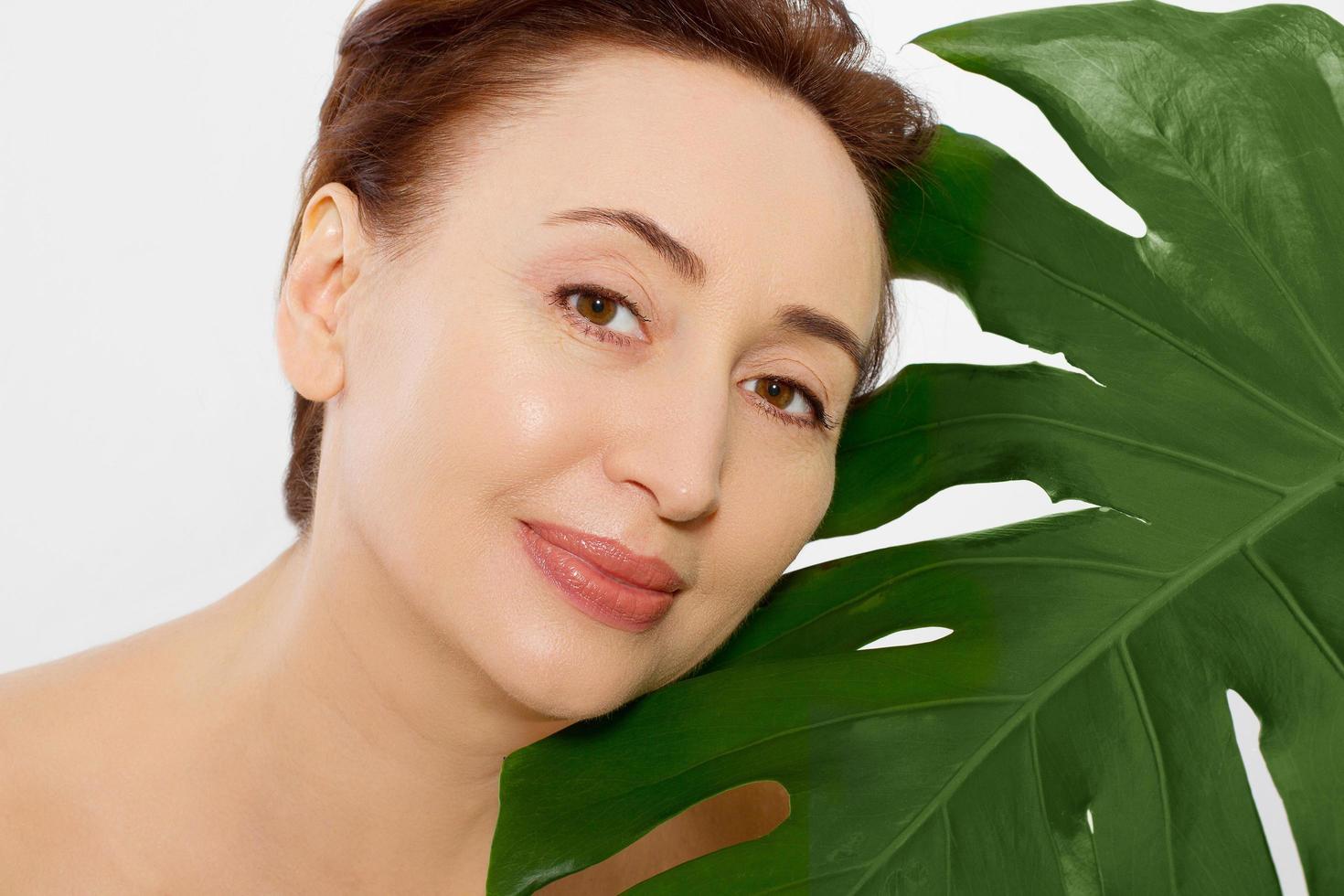 Beauty wrinkle middle age woman face portrait. Spa and anti aging concept Isolated on white background. Plastic surgery and collagen face injections. Wrinkles and menopause. Copy space photo