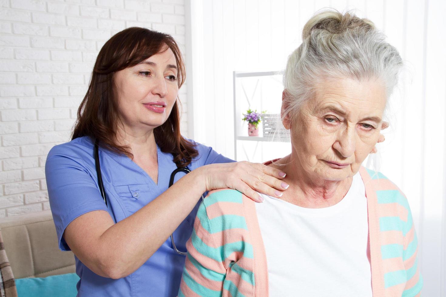 Una anciana y un médico de rehabilitación: concepto de rehabilitación y salud de las personas mayores foto