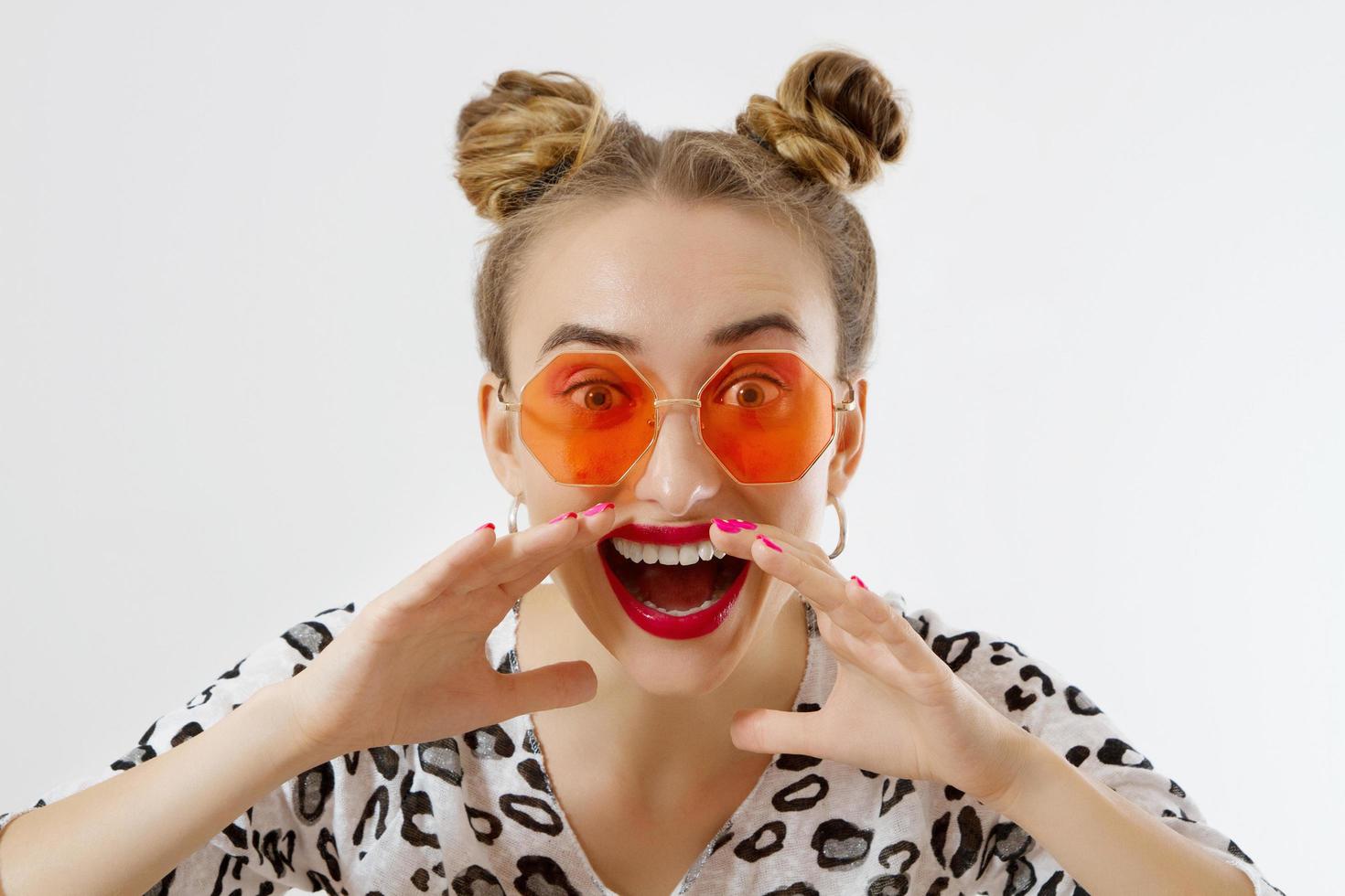 Shouting woman face. Fashion female closeup in trendy clothes isolated on white background. Summer fun time and summertime accessories. Funny girl. photo