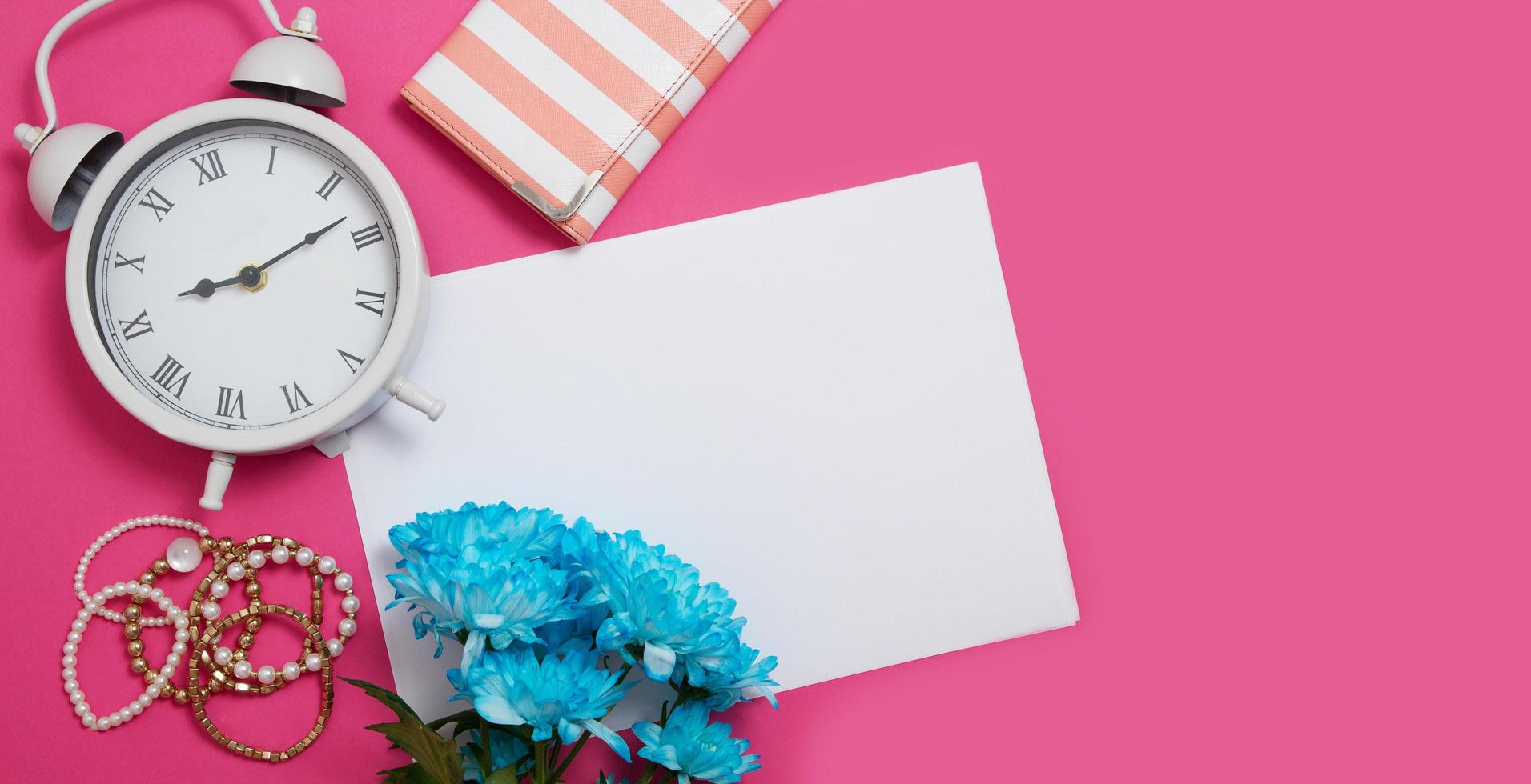 Workspace with copy space. Woman fashion mood board accessories on pink background. Clock and flowers mock up. Top view and teenager desktop. Summer style and template mock up. Banner photo