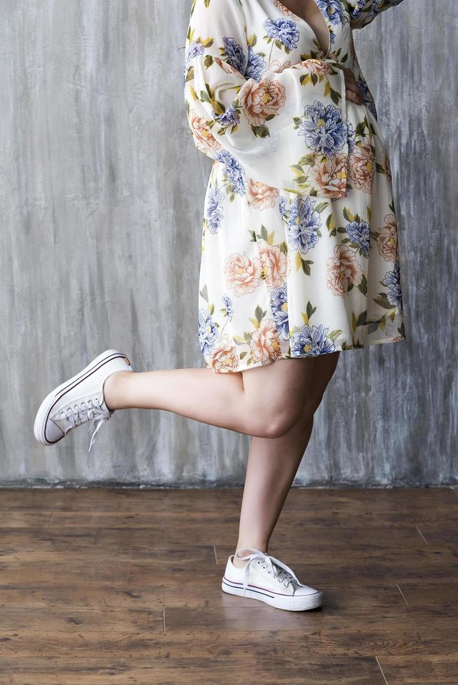 Smooth female legs on a grey background photo