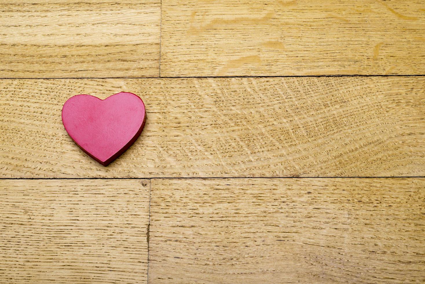 Heart on the wooden floor. photo