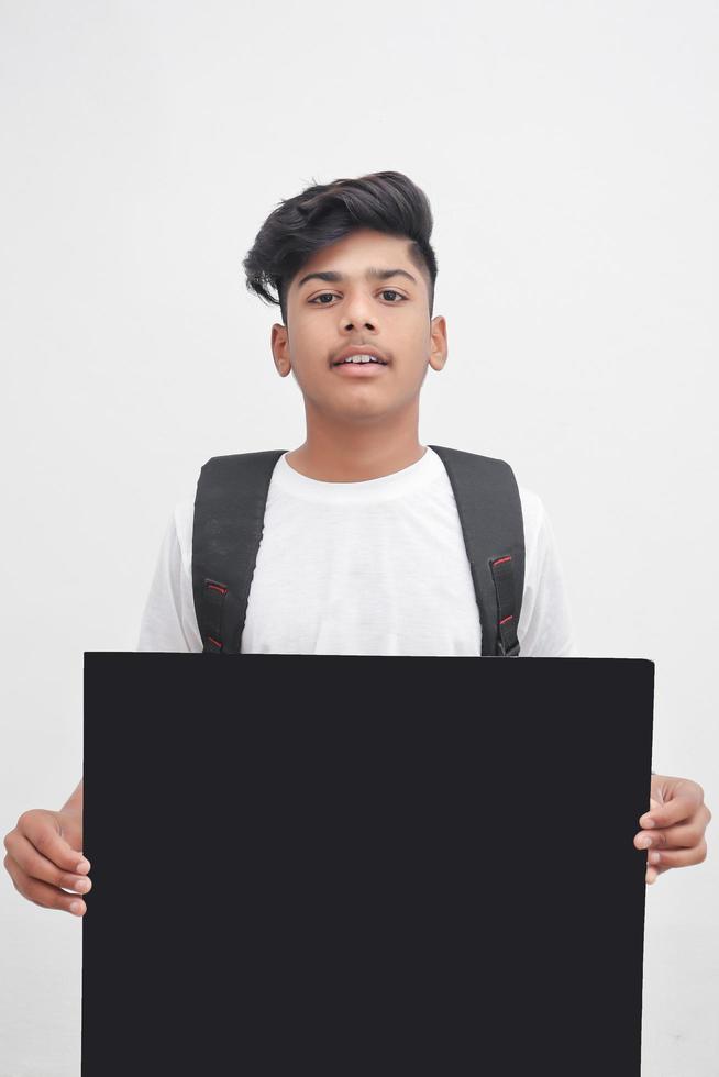 Indian college student showing board on white background. photo