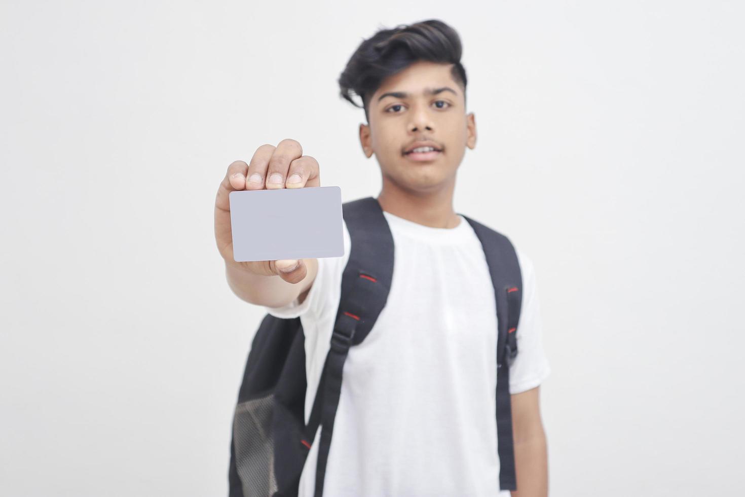 Indian college student showing card on white background. photo