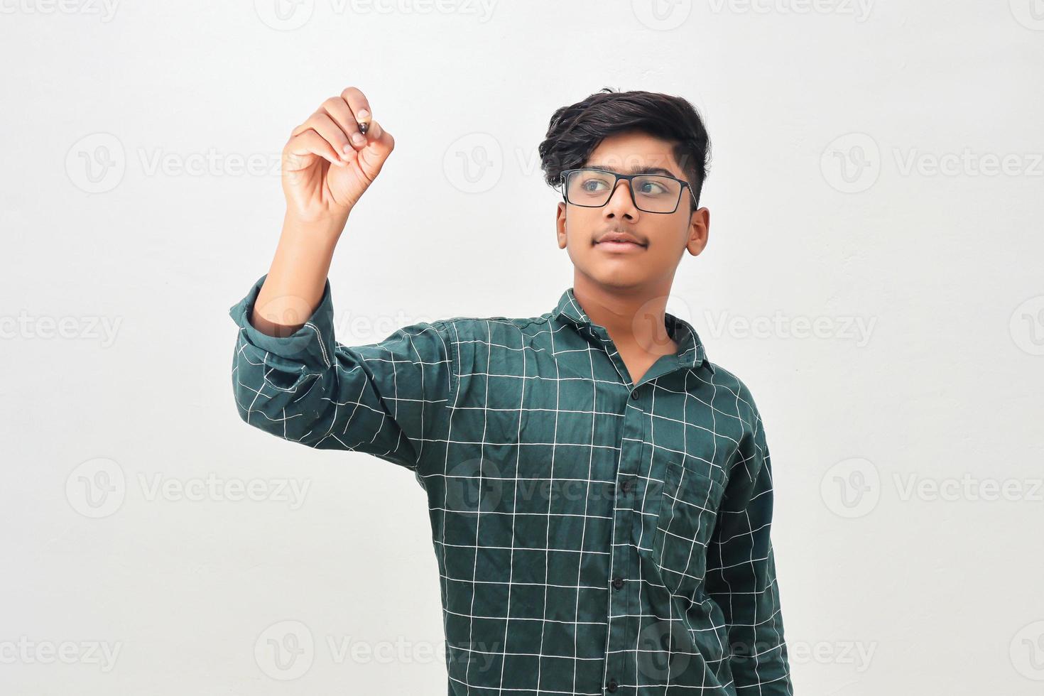 Young indian man wearing glasses and writing photo