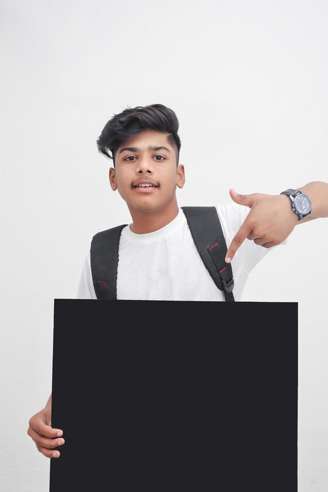 Indian college student showing board on white background. photo