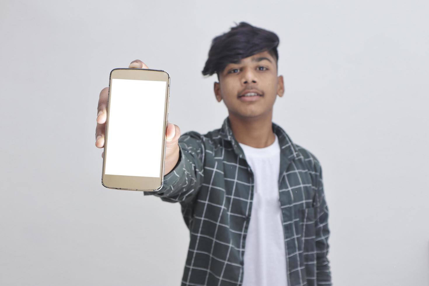 Indian college student showing mobile screen on white background. photo
