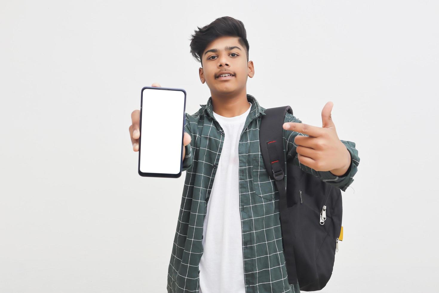 Indian college student showing mobile screen on white background. photo