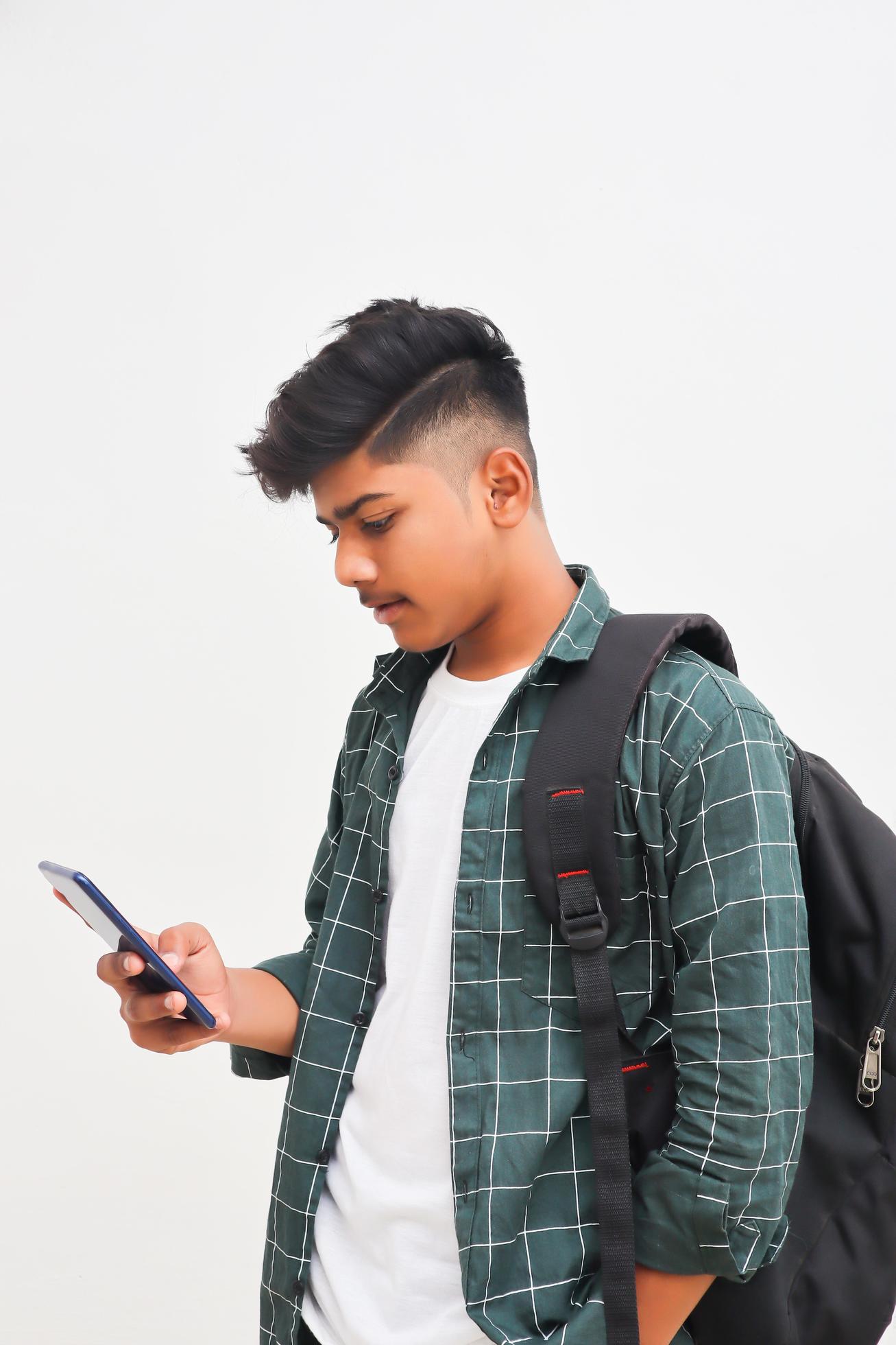 Young indian Boy using smartphone on white background. 5219901 Stock Photo  at Vecteezy