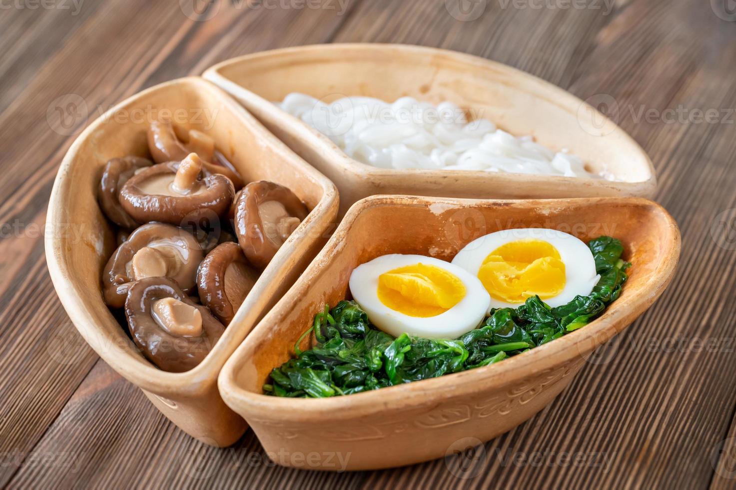 Bowl with rice noodles, mushrooms and spinach photo