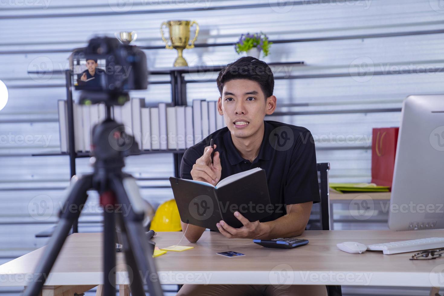 asian man blogger present and review product video broadcast live stream video to a social network. blogging, vlogging, online shopping, and social media concept photo