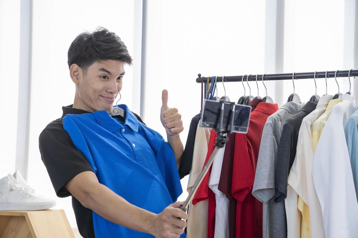 asian man blogger present and review product video broadcast live stream video to a social network. blogging, vlogging, online shopping, and social media concept photo