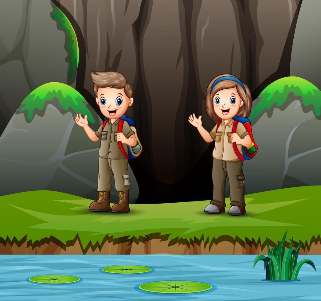 Cartoon boy and girl scout in nature vector