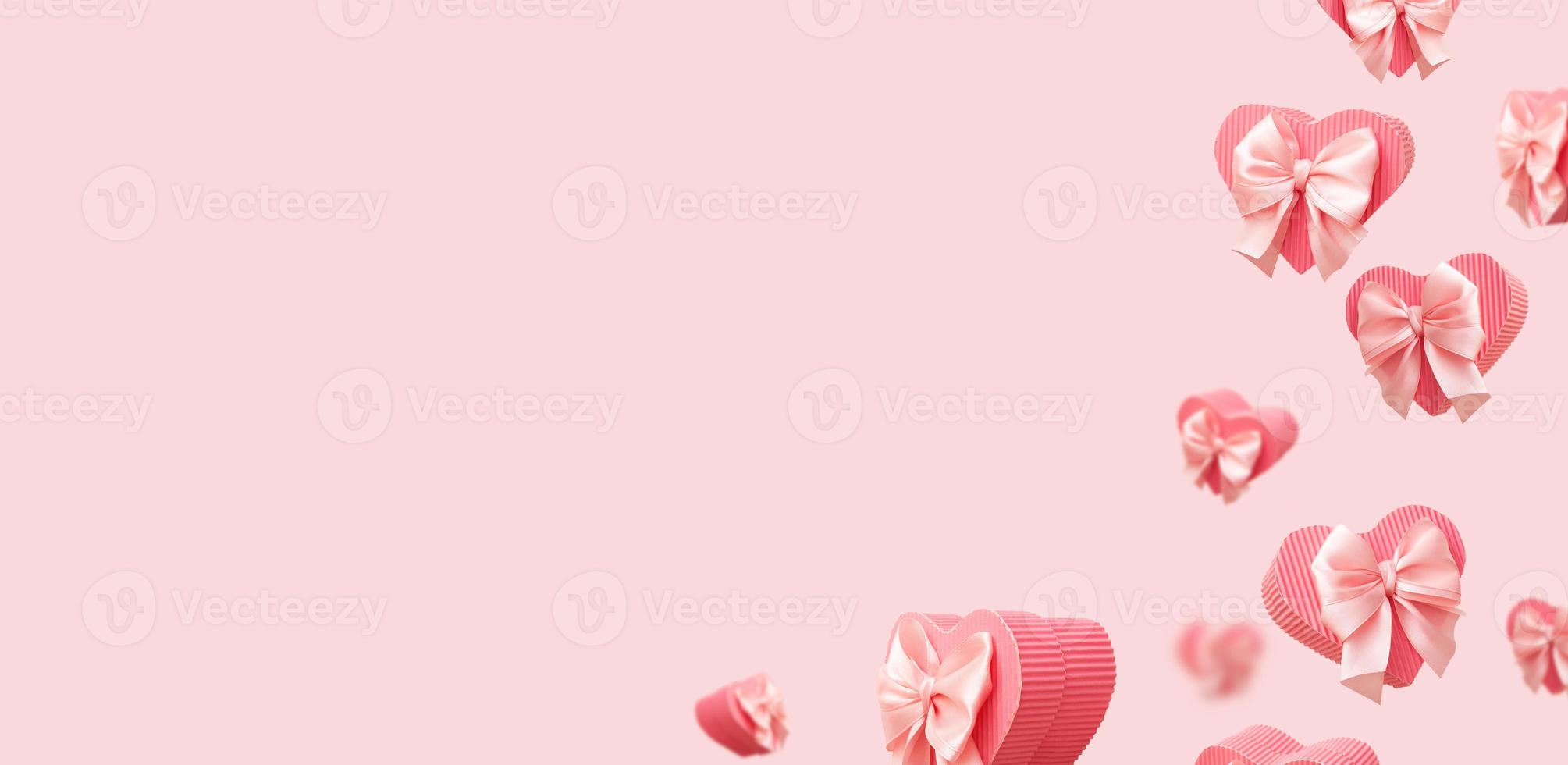 Banner with flying pink heart shaped gift boxes isolated on pink background. Trendy monochrome valentines day greeting card or banner photo