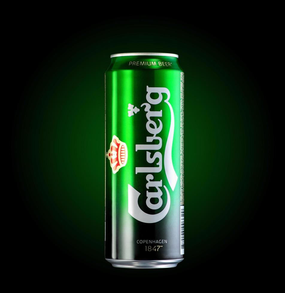 Almaty, Kazakhstan  October 11, 2019 can of beer Carlsberg in a green background with illumination. Advertising a brand of beer photo