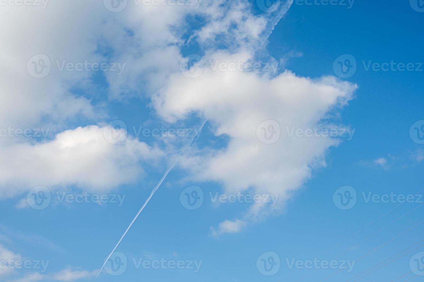 The plane's wake across the sky is like a cloud photo