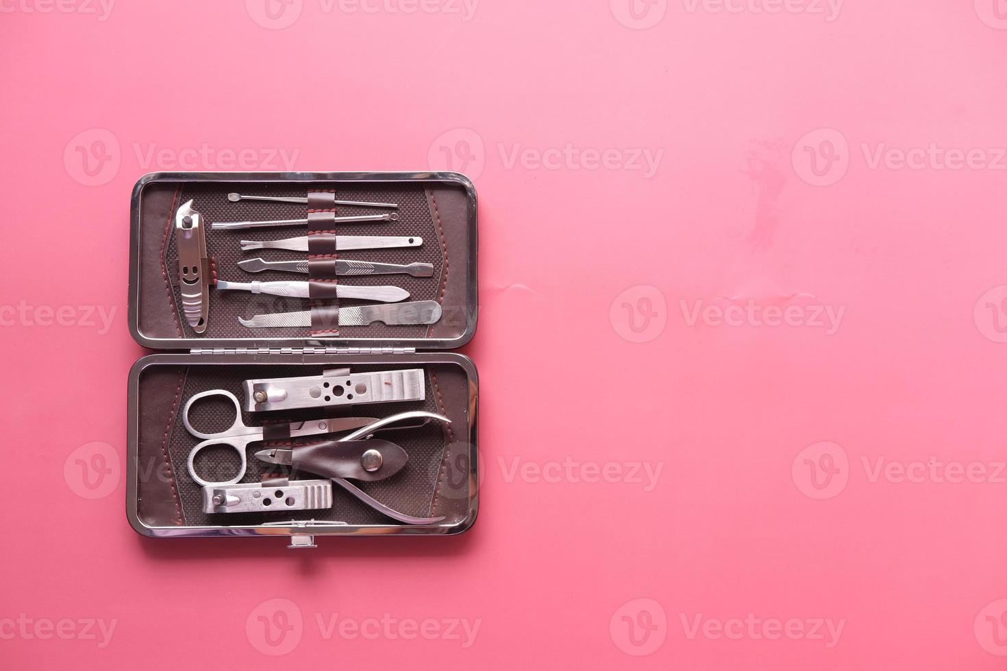 nail cutters for a manicure on red background photo