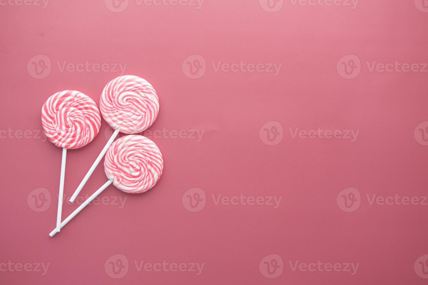 top view of pink color candy on color background photo