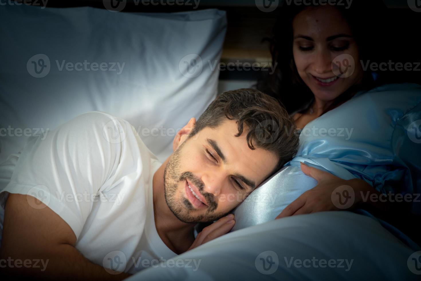 Pregnant woman with husband in bedroom with the atmosphere of having fun talking photo