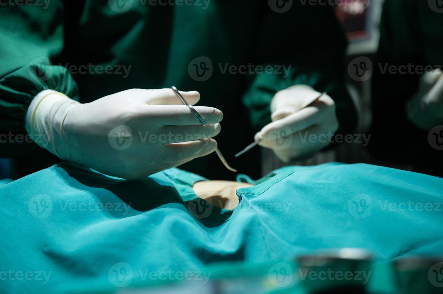 professional surgeon doctor team are working for surgery in medical operating room at hospital photo