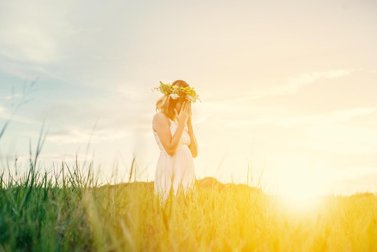 Young woman close her face with hands feeling lonely and sad when she standing alone at meadows. photo