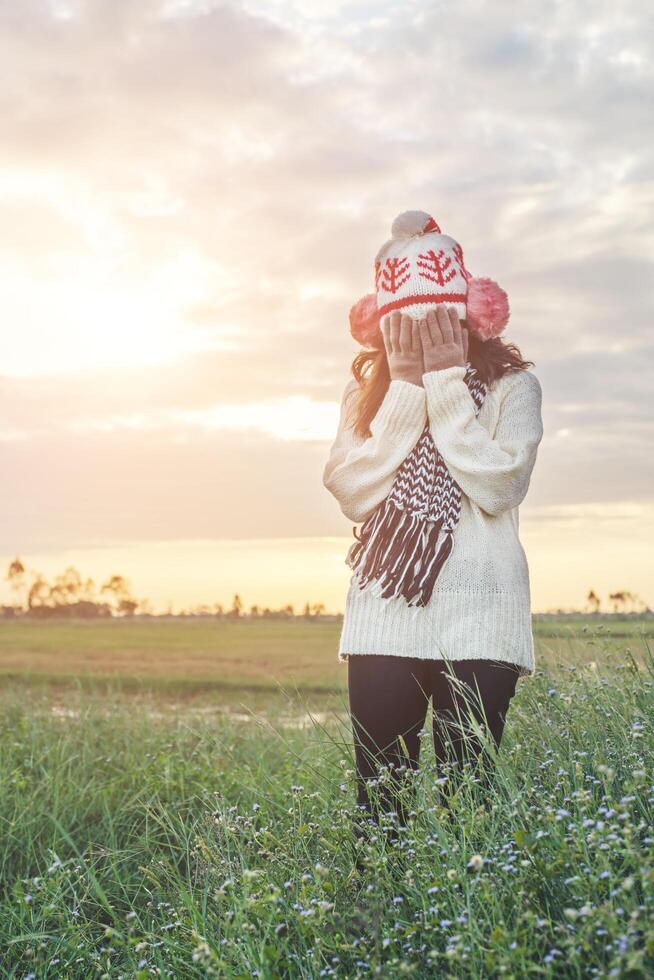 Silhouette of the woman standing lonely at the field during sunset. photo