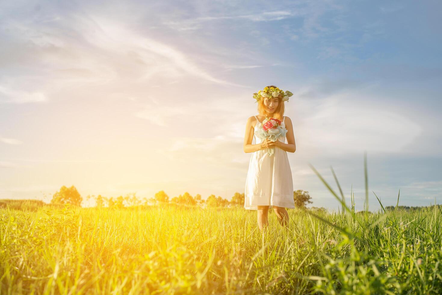 Young beautiful woman holding bouquet pink flowers in the meadows. photo