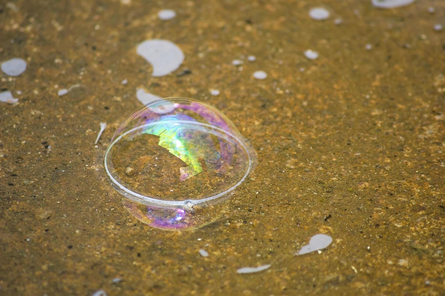 Water bubble falling on the ground photo
