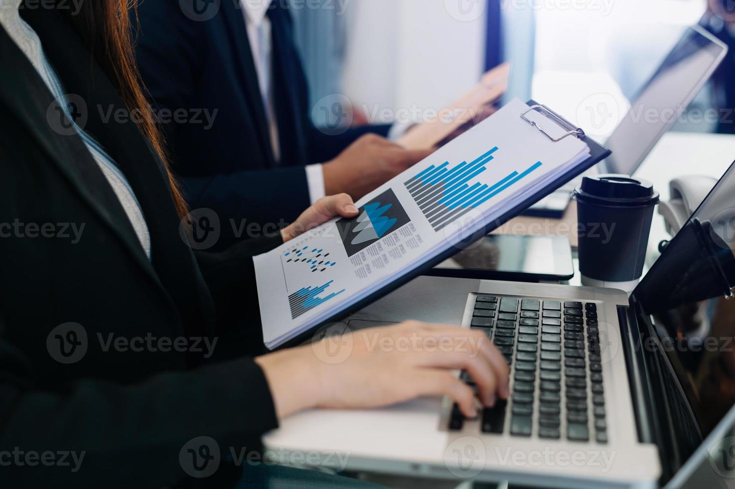 Team business meeting presentation. Hand businessman working project in modern office.Laptop computer and tablet and smart phone on white desk in morning light photo