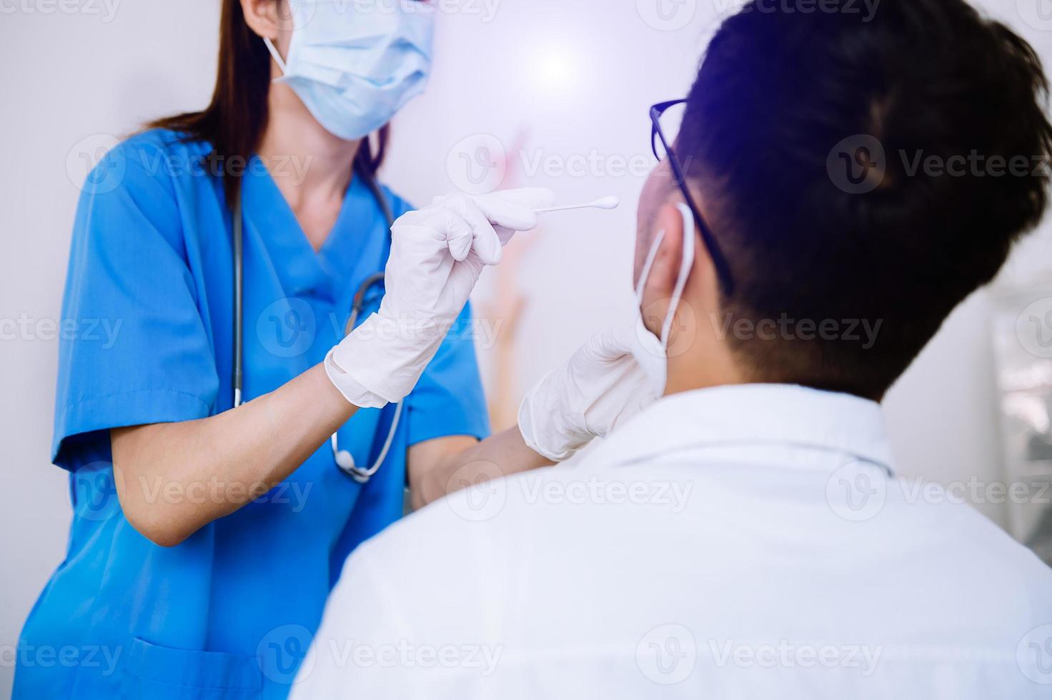 Doctor doing Covid-19 or Coronavirus test or DNA test to a young woman with nasal swab probe, photo