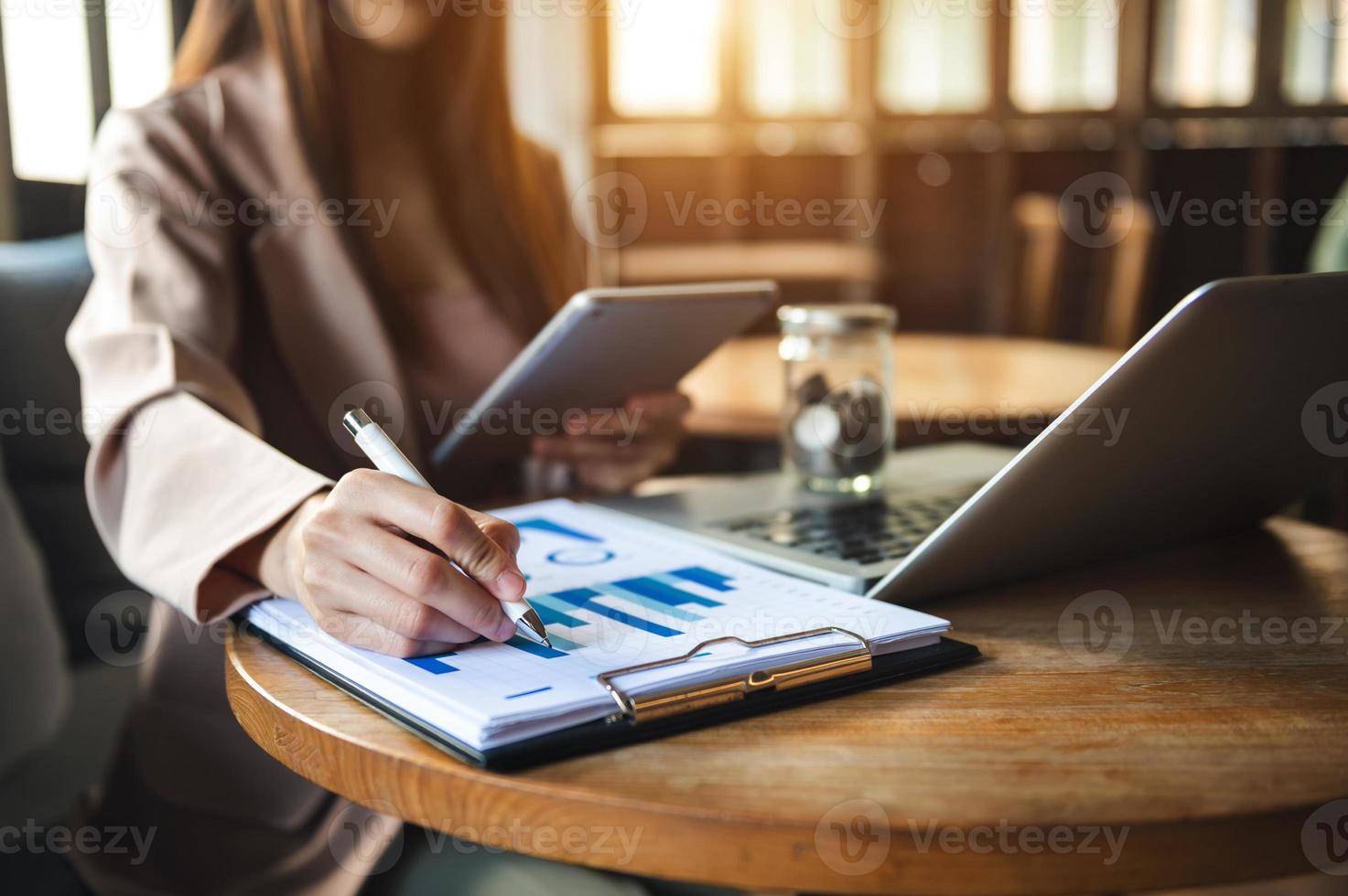 Women counting coins on calculator taking from the piggy bank. photo