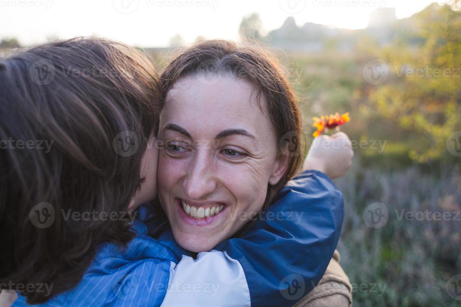 Boy kisses and hugs mom, happy motherhood photo