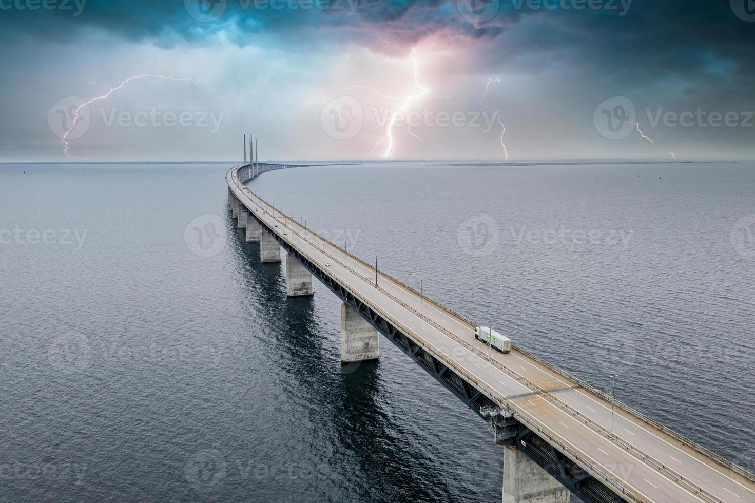 Panoramic view of Oresund bridge during thunderstorm and lightning over the Baltic sea photo