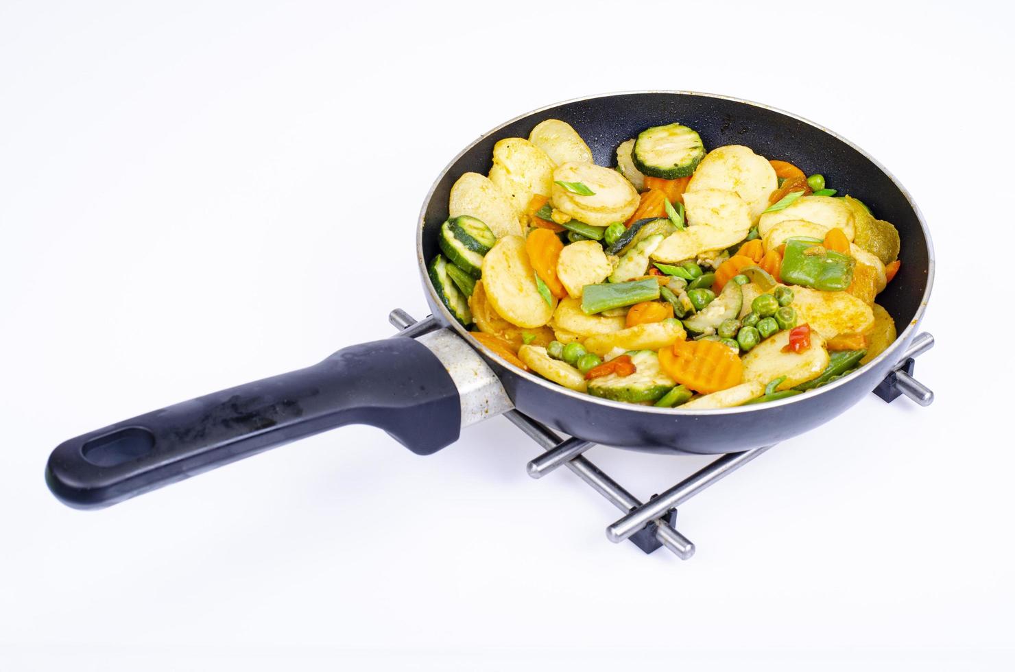 Mix of frozen organic vegetables fried in pan. Studio Photo