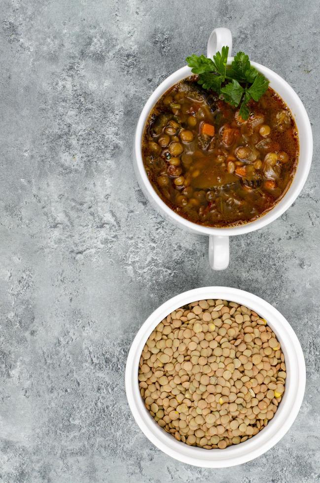 Vegetable soup with lentils in white plate. Studio Photo