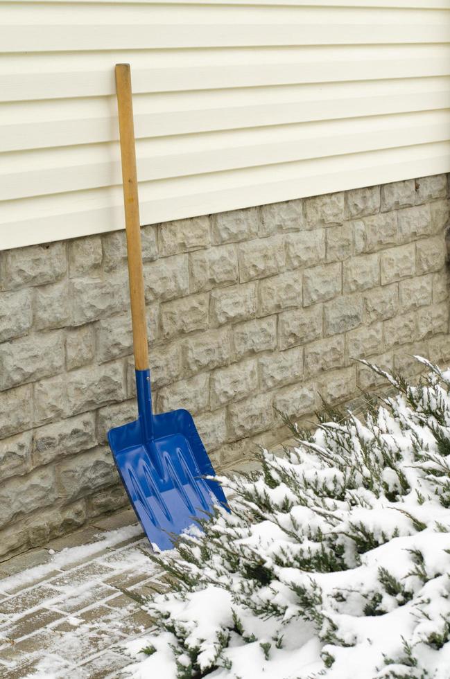 Snow shovel in the yard. Studio Photo