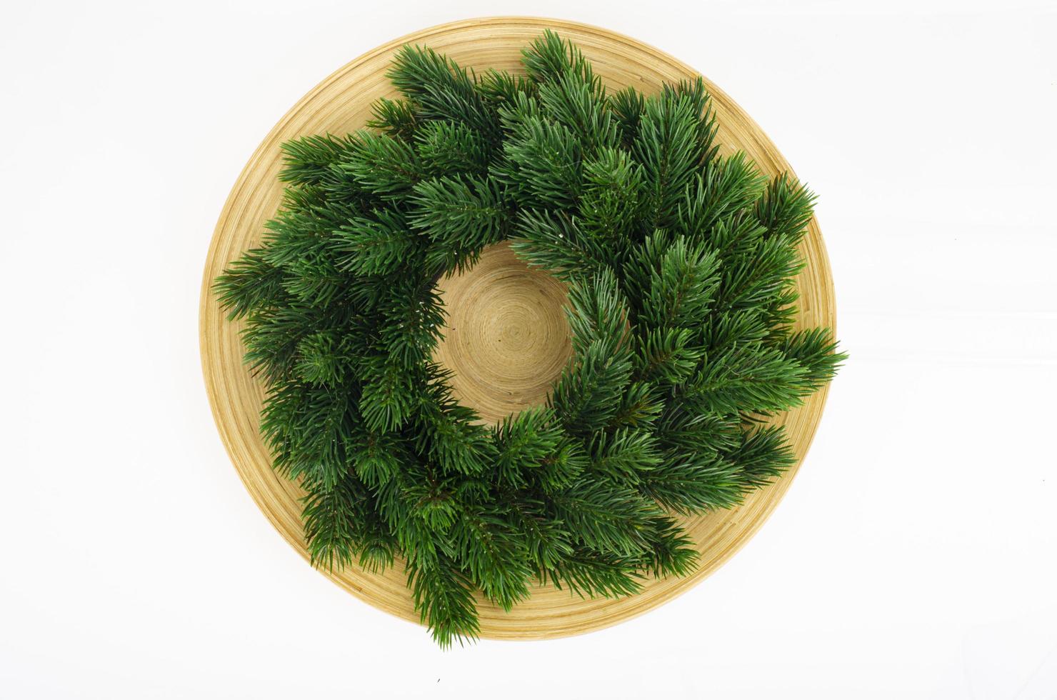 Christmas wreath with tangerines and plate. Studio Photo