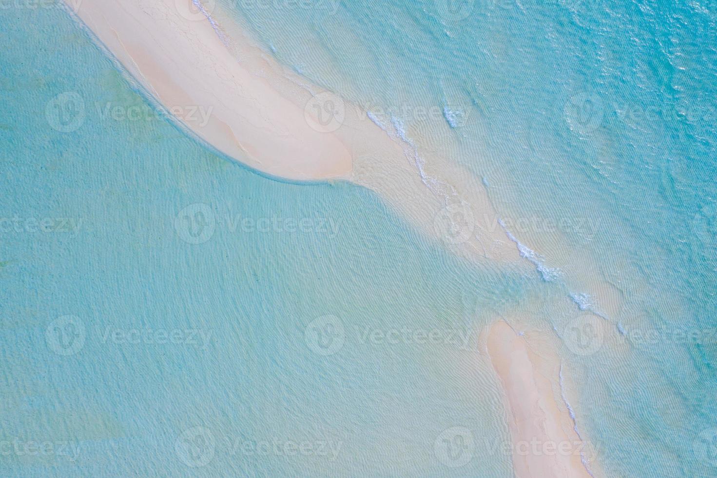 Summer seascape beautiful waves, blue sea water in sunny day. Top view from drone. Sea aerial view, amazing tropical nature background. Beautiful bright sea with waves splashing and beach sand concept photo