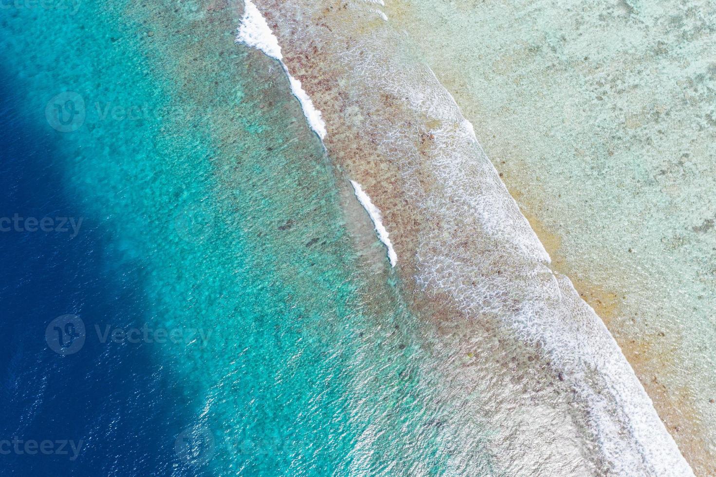 Summer seascape beautiful waves, blue sea water in sunny day. Top view from drone. Sea aerial view, amazing tropical nature background. Beautiful bright sea with waves splashing and beach sand concept photo