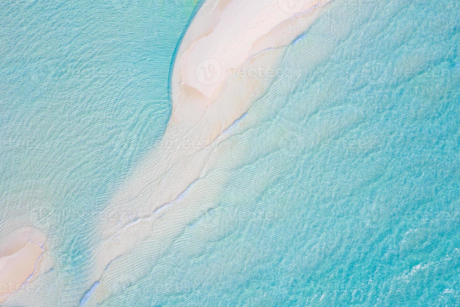 Summer seascape beautiful waves, blue sea water in sunny day. Top view from drone. Sea aerial view, amazing tropical nature background. Beautiful bright sea with waves splashing and beach sand concept photo