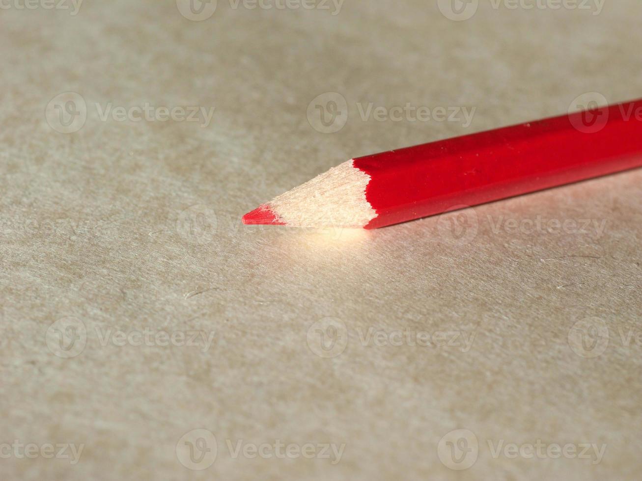 Red pencil over paper photo