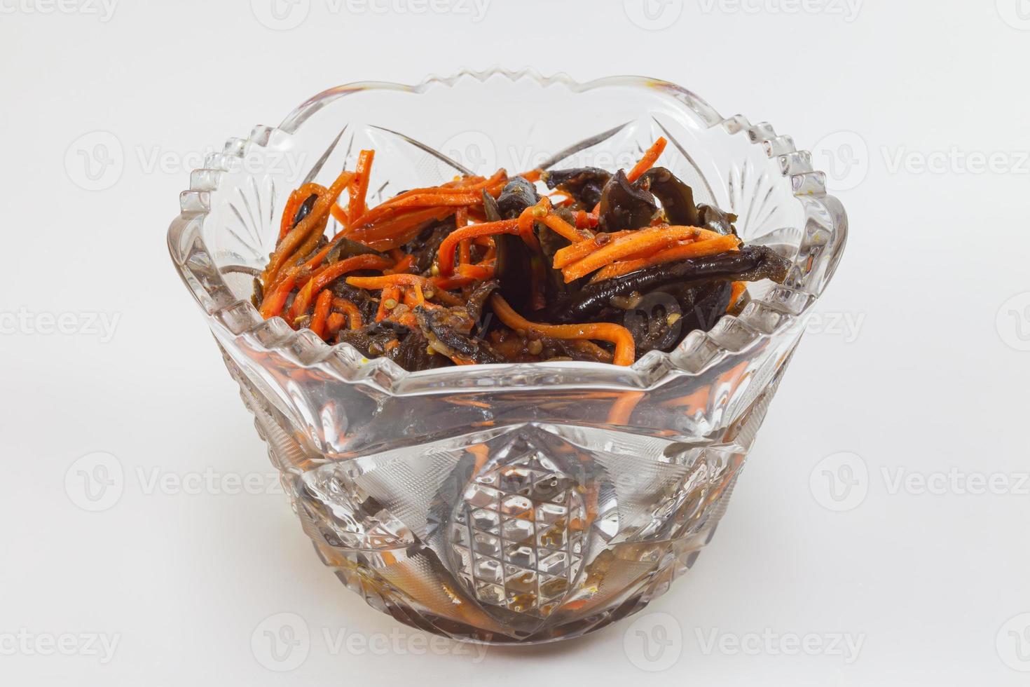 Pickled eggplant with carrots in a plate on a white background photo