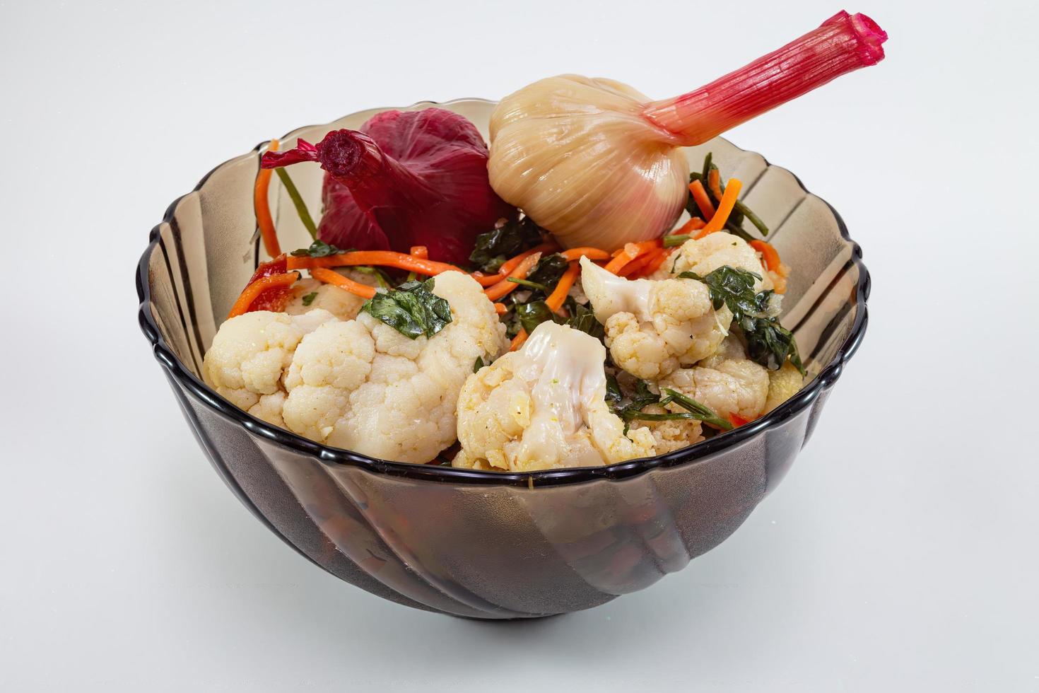 Pickled garlic with cauliflower in a plate photo