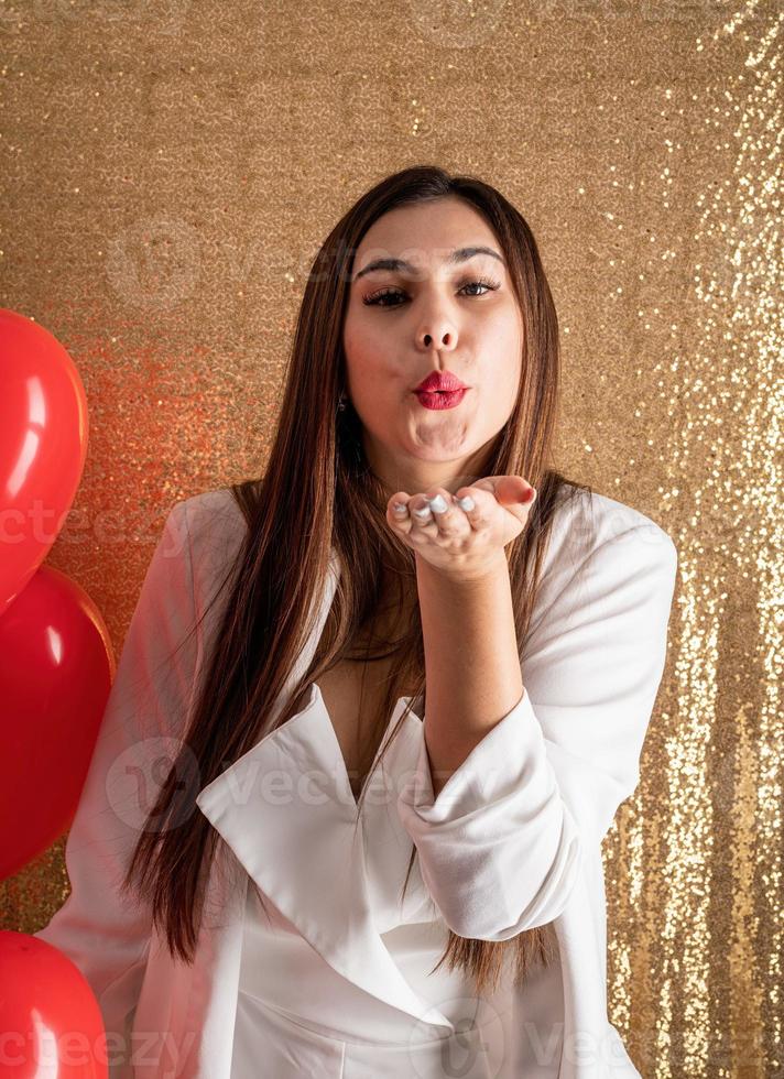 Valentine's day, Women's day. Young caucasian brunette woman sitting in the bed celebrating valentine day working on laptop online photo