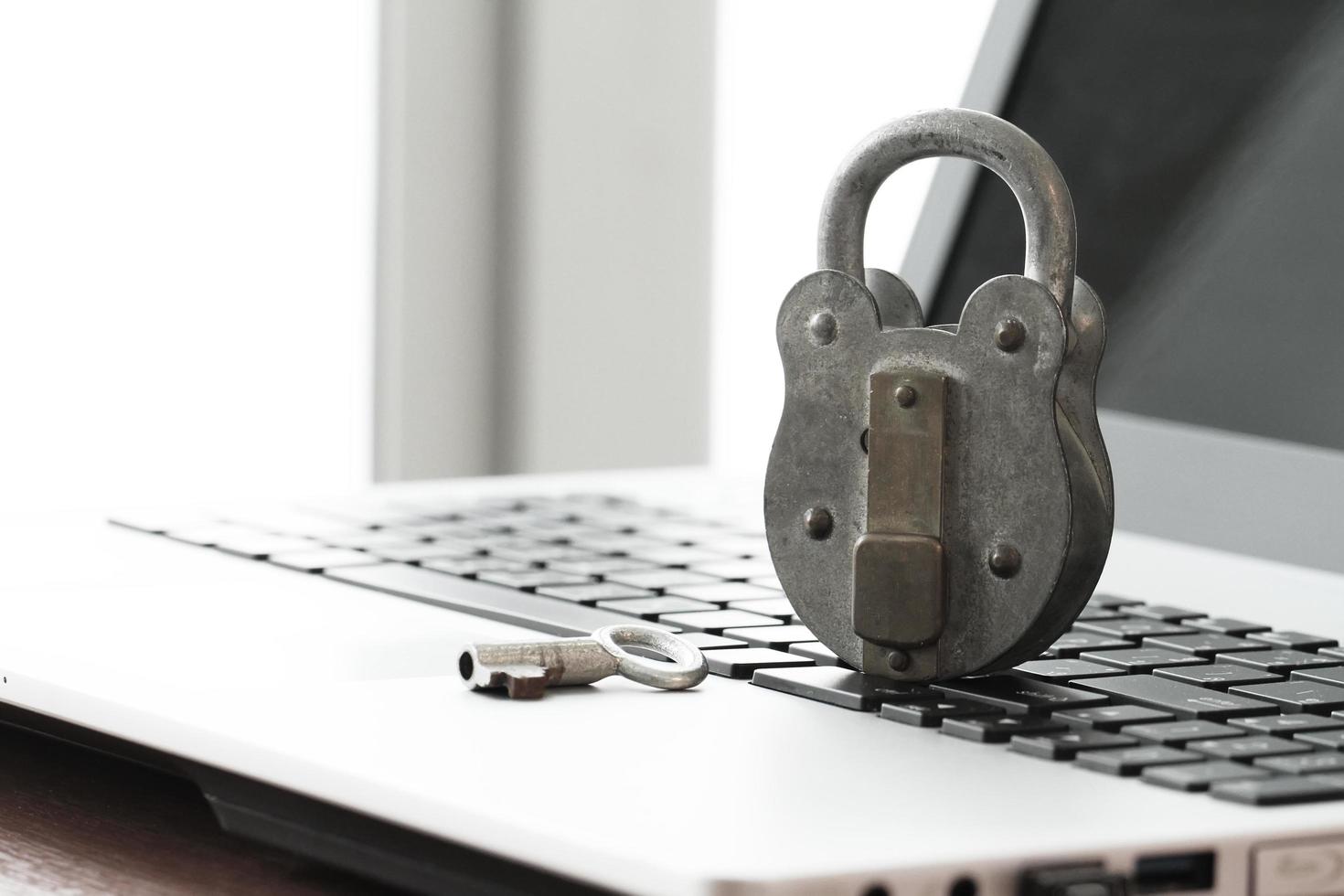 Internet security concept-old padlock and key on laptop computer keyboard photo