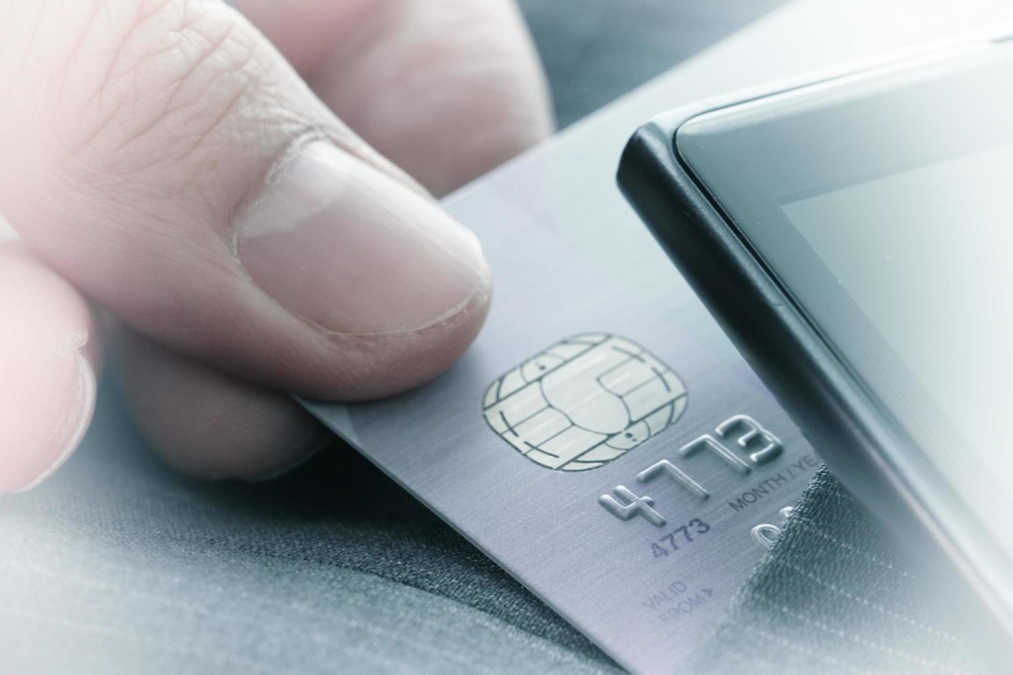 Credit cards in very shallow focus with gray suit background as online shopping concept photo