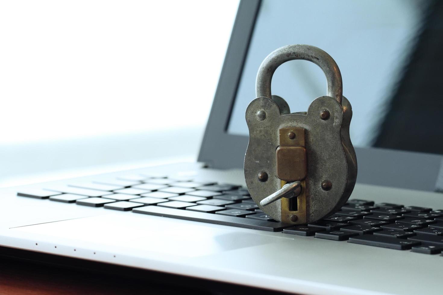 Internet security concept-old padlock and key on laptop computer keyboard photo