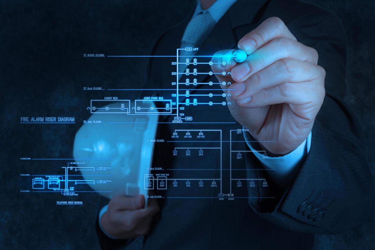 engineer draws an electronic single line and fire alarm riser schematic photo